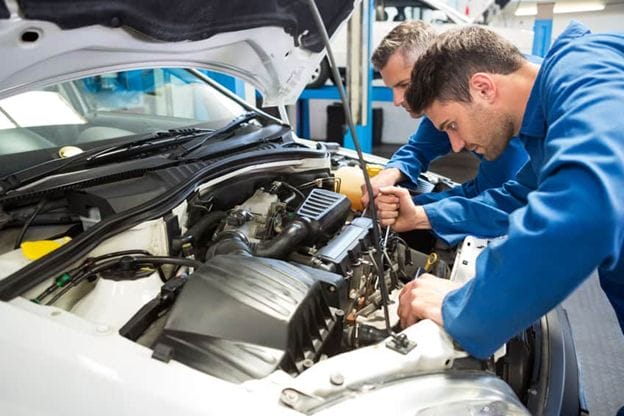 A group of men working on a car
